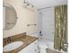 Clean bathroom with granite countertop, white cabinets, and a tub shower combo at 7625 Sun Island S Dr # 101, South Pasadena, FL 33707