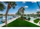 Landscaped grounds with a view of the building, marina, and tennis courts at 7625 Sun Island S Dr # 101, South Pasadena, FL 33707