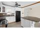 Modern kitchen with white cabinets, granite countertops, and black appliances at 7625 Sun Island S Dr # 101, South Pasadena, FL 33707