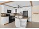 Modern kitchen with white cabinets, granite countertops, and black appliances at 7625 Sun Island S Dr # 101, South Pasadena, FL 33707