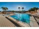 Community pool with hot tub, surrounded by palm trees and lounge chairs at 7625 Sun Island S Dr # 101, South Pasadena, FL 33707