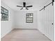 Bright bedroom with ceiling fan, window, and hardwood floors at 8816 Ashman Rd, Riverview, FL 33578