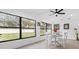Bright dining area with white table and chairs, large windows, and backyard view at 8816 Ashman Rd, Riverview, FL 33578