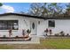 Newly renovated mid-century home with white brick exterior and modern front door at 8816 Ashman Rd, Riverview, FL 33578