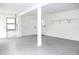 Clean garage with white walls, speckled floor, and storage shelves at 8816 Ashman Rd, Riverview, FL 33578
