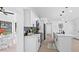 Modern kitchen with white cabinets and island, open to living room at 8816 Ashman Rd, Riverview, FL 33578