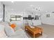 Open concept living room and kitchen with light floors and modern decor at 8816 Ashman Rd, Riverview, FL 33578