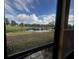 View of a pond and lush landscape from a patio at 200 Country Club Dr # 1503, Largo, FL 33771