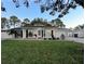 White house with green lawn, updated landscaping, and a paved driveway at 2353 Kilgore Dr, Largo, FL 33770