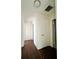 Clean hallway with dark brown wood-look flooring and white walls at 2353 Kilgore Dr, Largo, FL 33770