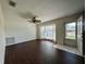 Bright living room with bay window, dark laminate floors, and ceiling fan at 2353 Kilgore Dr, Largo, FL 33770