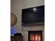 Modern fireplace with stone surround and wood mantel at 5476 Oakridge Dr, Palm Harbor, FL 34685