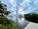 Scenic waterfront view with dock and calm water under cloudy skies at 25 S Treasure Dr, Tampa, FL 33609