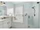 Bathroom with soaking tub, shower, and white cabinets at 3407 Fox Squirrel Ln, Valrico, FL 33594