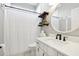 Bathroom with white vanity, round mirror, and shelves at 3407 Fox Squirrel Ln, Valrico, FL 33594