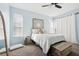 Bedroom with light blue walls, ceiling fan and large windows at 3407 Fox Squirrel Ln, Valrico, FL 33594