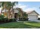 Single-story home with a two-car garage and well-manicured lawn at 3407 Fox Squirrel Ln, Valrico, FL 33594