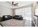 Living room features hardwood floors, ceiling fan, and ample natural light at 3407 Fox Squirrel Ln, Valrico, FL 33594