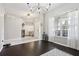 Open living area with dark hardwood floors and natural light at 3407 Fox Squirrel Ln, Valrico, FL 33594