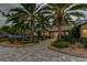 Landscaped front yard with a paved driveway and palm trees at 2420 Kent Pl, Clearwater, FL 33764