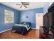 Blue bedroom with wood floors and a flat-screen TV at 6232 French Creek Ct, Ellenton, FL 34222