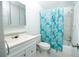 Bathroom with shower/tub, white vanity, and blue shower curtain at 6382 81St N Ave, Pinellas Park, FL 33781