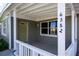 Covered porch with white railings and a green door at 6382 81St N Ave, Pinellas Park, FL 33781