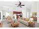 Living room with beige sofa and coffee table, open to kitchen at 11136 Ancient Futures Dr, Tampa, FL 33647