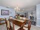 Formal dining room features a chandelier and elegant wooden table at 3358 Tanglewood Trl, Palm Harbor, FL 34685