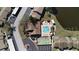 Overhead view of the community pool, tennis court, and tranquil lake at 3840 Staysail Ln # 3840, Holiday, FL 34691