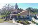 Exterior of the lovely clubhouse, showcasing landscaping, architecture, and walkway at 3840 Staysail Ln # 3840, Holiday, FL 34691