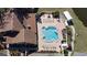 Aerial view of the community pool, lounge chairs, and tennis courts at 3840 Staysail Ln # 3840, Holiday, FL 34691