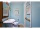 Light blue bathroom with pedestal sink and tiled floor at 4302 W Obispo St, Tampa, FL 33629