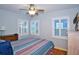 Bedroom with hardwood floors, window shutters, and ceiling fan at 4302 W Obispo St, Tampa, FL 33629