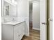 Updated bathroom with a white vanity, modern fixtures and a large mirror at 5875 21St N St # 15L, St Petersburg, FL 33714