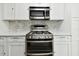 Stainless steel appliances and white cabinets highlight this updated kitchen at 5875 21St N St # 15L, St Petersburg, FL 33714