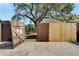 View of a partially new wooden fence and gate at 2905 N 13Th St, Tampa, FL 33605