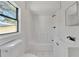 Updated bathroom with white vanity and bathtub/shower combo at 2905 N 13Th St, Tampa, FL 33605