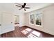 Spacious bedroom with hardwood floors, ceiling fan, and large windows at 2905 N 13Th St, Tampa, FL 33605