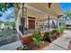 Charming yellow house with a red door and a wraparound porch at 2905 N 13Th St, Tampa, FL 33605