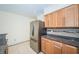 Well-equipped kitchen with stainless steel refrigerator, wooden cabinets, and granite countertops at 4144 56Th N St # 810, Kenneth City, FL 33709