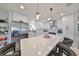 Modern kitchen with white cabinets, stainless steel appliances, and a large island at 2019 N Pebble Beach Blvd, Sun City Center, FL 33573