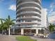 Stunning exterior view of a modern high-rise condominium building featuring curved balconies, retail and restaurant space at 400 Central Ave # 3909, St Petersburg, FL 33701