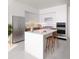 Modern kitchen featuring a marble island, stainless steel appliances, and sleek white cabinets at 400 Central Ave # 3909, St Petersburg, FL 33701