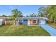 Ranch style home with solar panels and landscaped lawn at 754 Melody Ln, Bradenton, FL 34207