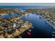 Expansive aerial view of waterfront homes, showcasing stunning bay and city views with lush landscaping and private boat docks at 1100 Monterey Ne Blvd, St Petersburg, FL 33704