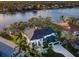Stunning waterfront home with a metal roof, lush landscaping, and a private boat dock along a serene waterway at 1100 Monterey Ne Blvd, St Petersburg, FL 33704