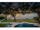 Landscaped backyard with manicured lawn, pool, and views of the water at 1100 Monterey Ne Blvd, St Petersburg, FL 33704