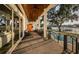 Spacious covered backyard patio with outdoor seating overlooking pool and waterfront at 1100 Monterey Ne Blvd, St Petersburg, FL 33704