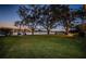 Gorgeous waterfront home with lush green lawn, mature trees and waterfront view at 1100 Monterey Ne Blvd, St Petersburg, FL 33704